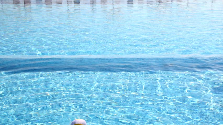 Boy walked along the parapet and jumped into the water, girl swims not far