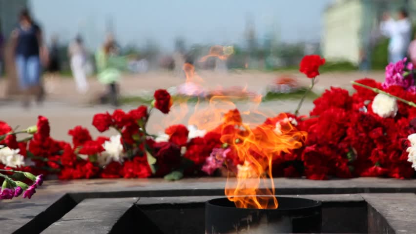 Eternal fire burns in afternoon at Monument to victims of revolution on Mars field