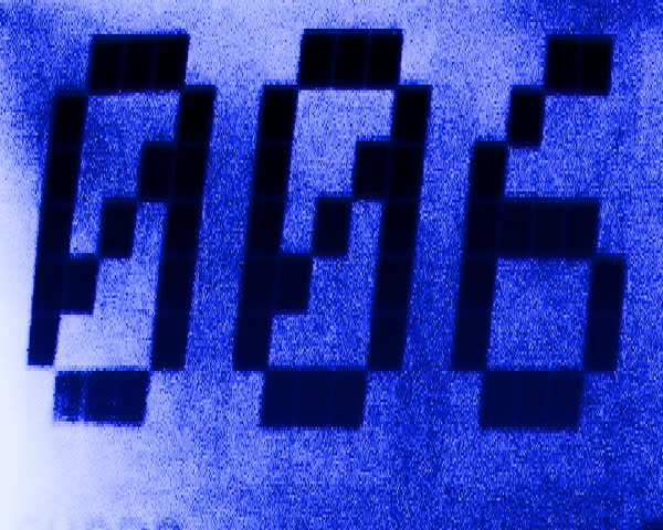Digital numbers randomly showing on a modern grainy background. Video 2 of a set of 2 Videos.