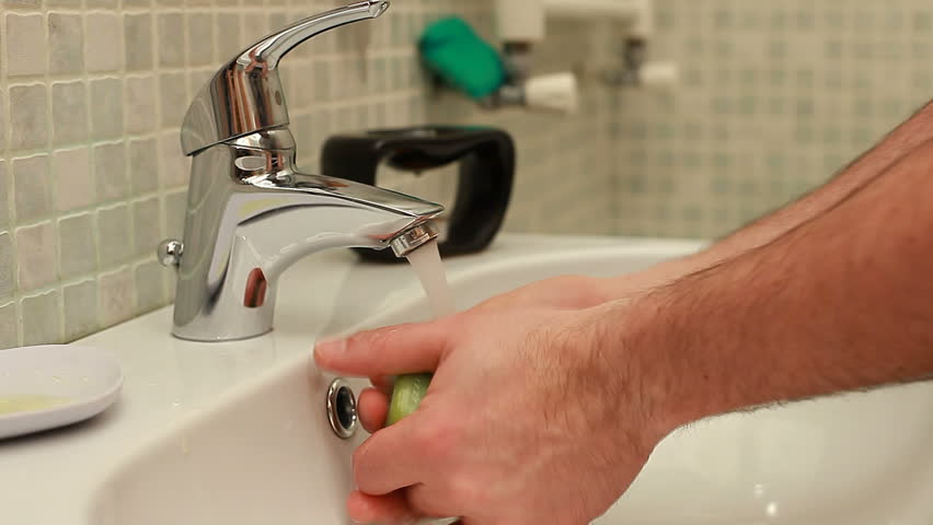 Washing hands in faucet