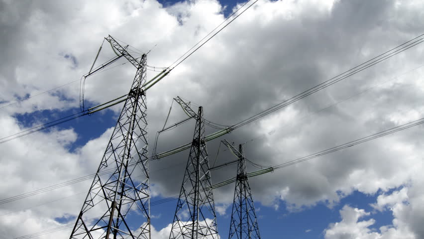 wide angle view of high voltage power pylons on against sky