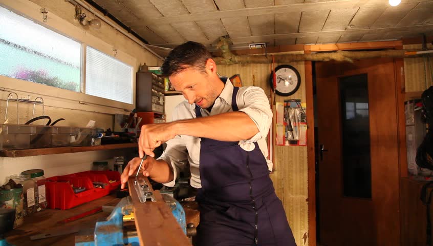 Joiner working wood in workshop