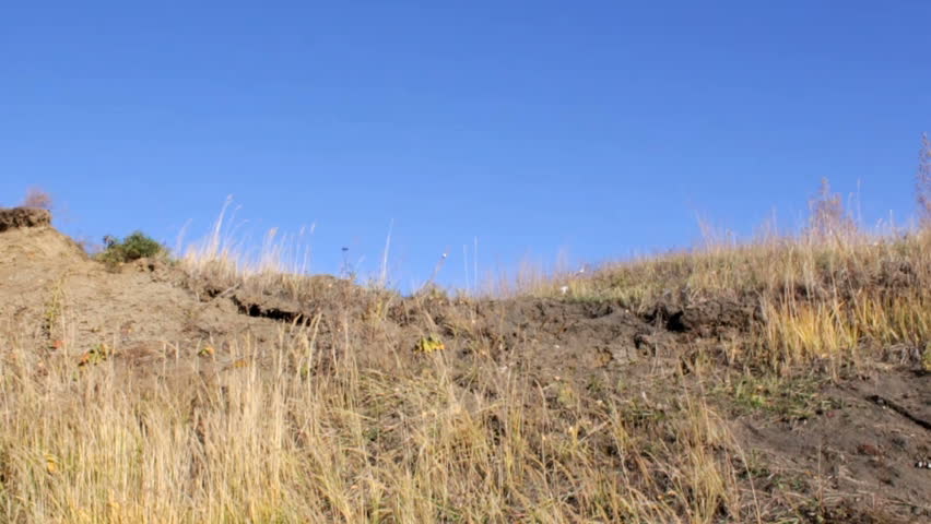 Slow motion shot with a bicycle rider making a step down jump, then another one and passing the camera. 