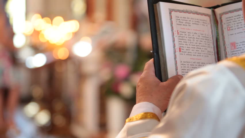 Priest reading the Bible in church