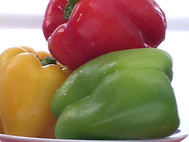 A rotating display of red, green and yellow peppers