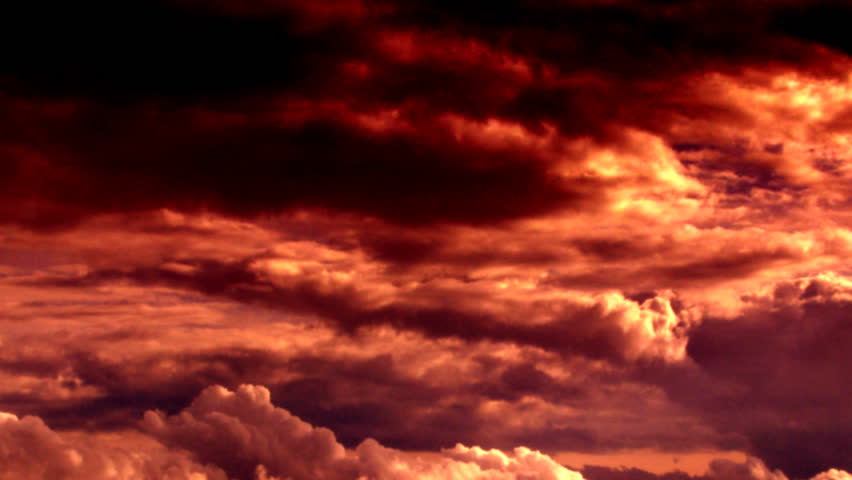 Dramatic clouds formatting storm in bright colors during sunset.