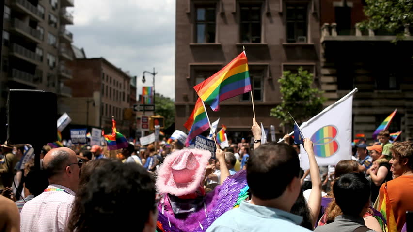 NEW YORK CITY - JUNE 26: Crowd waving Gay Pride Flags at NYC Gay Pride Parade, June 26, 2011, New York City. The annual parade took on extra significance following the legalization of same-sex marriage in New York on June 24, 2011.