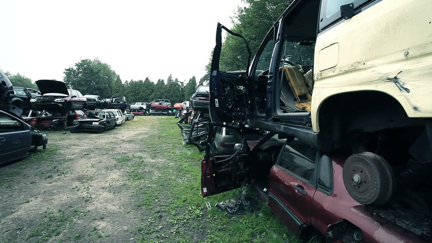 damaged cars in junkyard where parts can be recycled