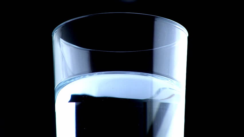 Aspirin in glass of water in studio