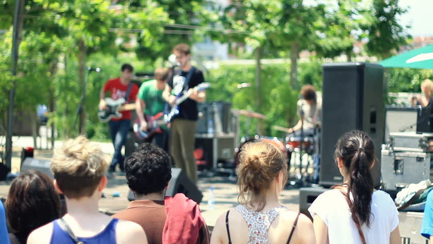 People standing at rock concert, camera stabilizer shot
