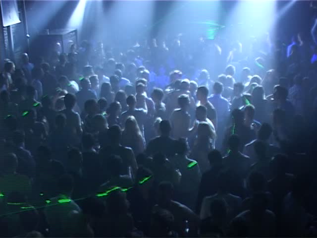 Blue lights on crowded nightclub dancefloor