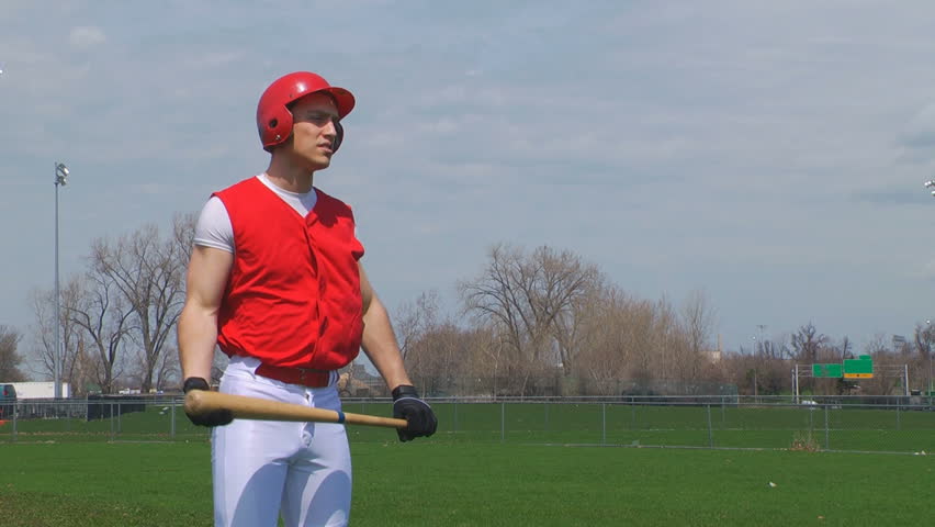 Young adult baseball player at playing field. Warming up.