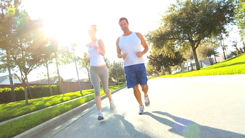 Active caucasian couple jogging to keep fit