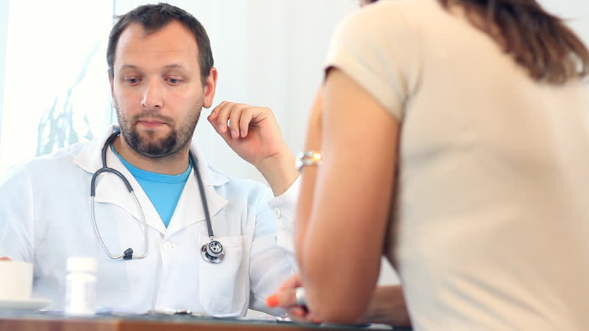 Male doctor telling bad news to female patient