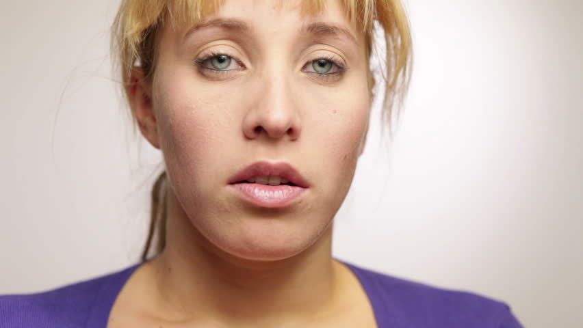 Frustrated young woman holding her hands in front of her face