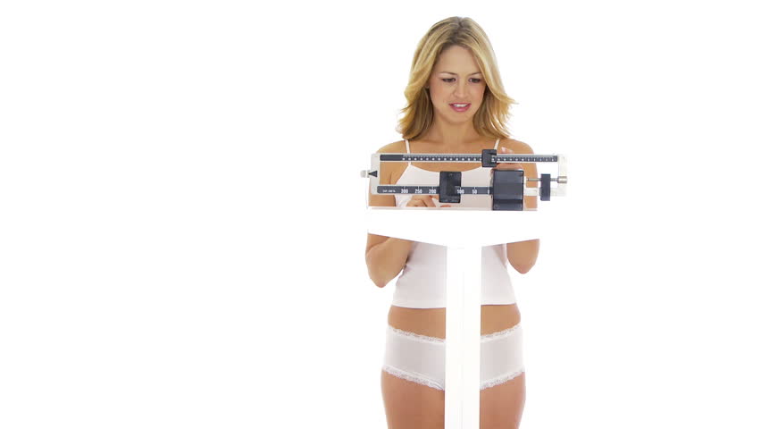 Young woman on scale happy about her weight