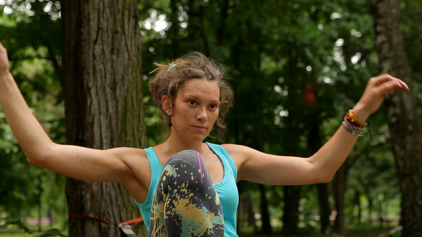 girl balances on the slackline