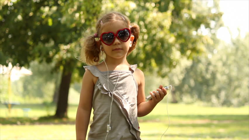 little girl listening music and dancing