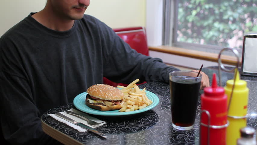 Unhealthy Eating, man eating fast food hamburger