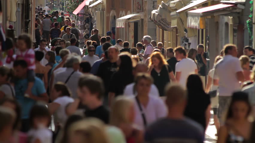 POREC, CROATIA - JULY 30: Tourists walking in a narrow street in Porec, Croatia, July 30, 2011. The town and municipality of Porec is almost 2,000 years old.