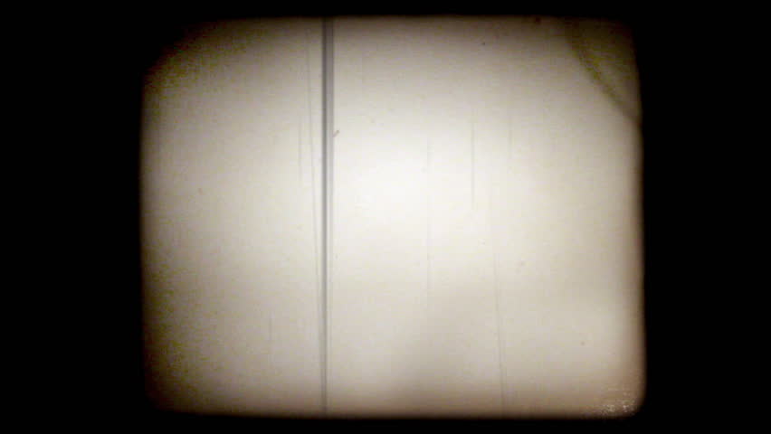 Old home movie of a man trying out a golf club in his yard with a vintage 8mm film look. Shots are recent, but very authentic looking. Includes projector audio.