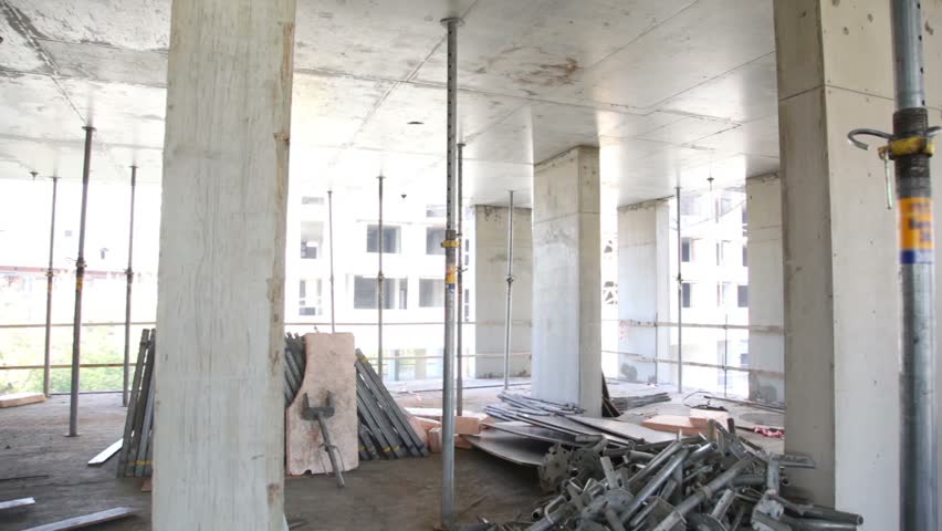 Panorama of unfinished level at construction site, few other buildings visible outside