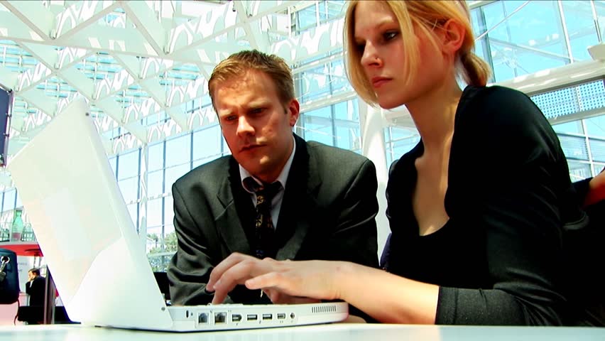 Business couple on a laptop at the conference