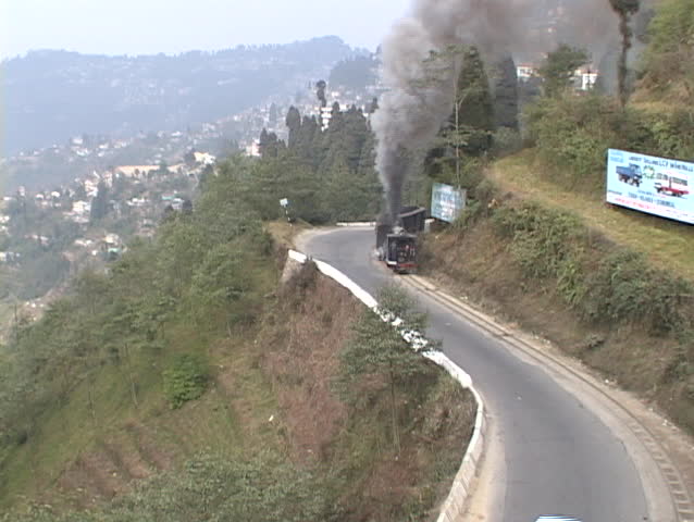 Steam train winds through the mountains near Darjeeling, India.