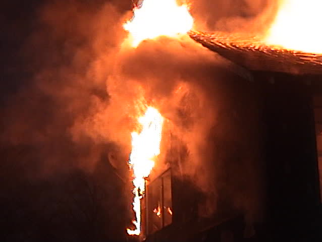 Fire along the roof line with falling debris