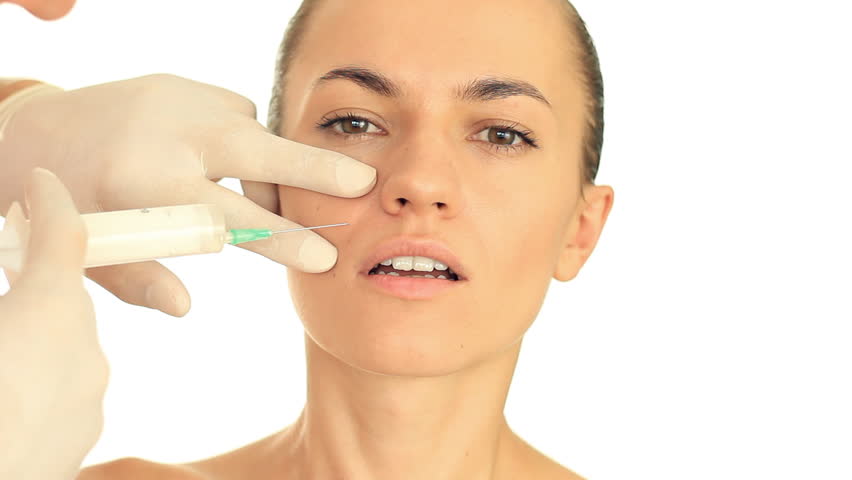 A young beautiful woman having an injection