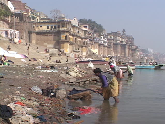 INDIA - CIRCA 2010: People wash clothes beside the Ganges River circa 2010 in Varanasi, India.