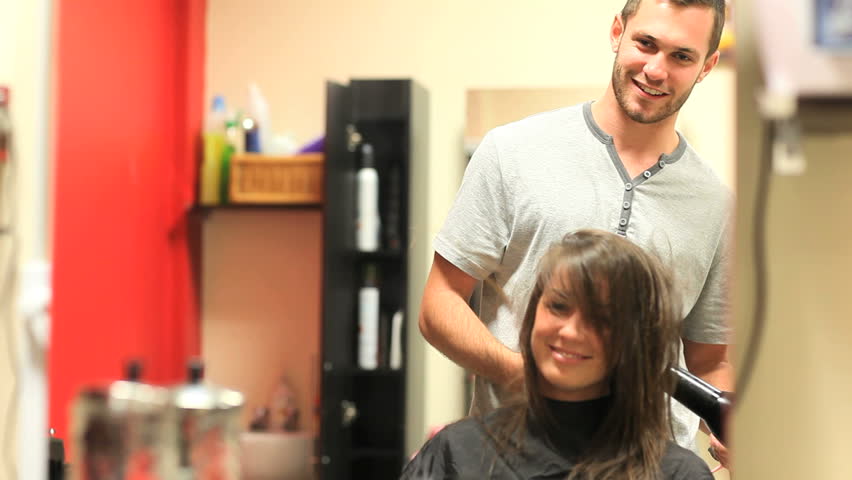 Hairdresser drying a student's hair in the IT