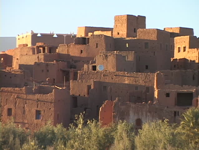 Adobe buildings crowd close together on a hillside.
