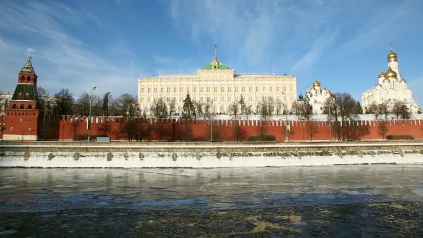 Embankment and red brick walls of Moscow Kremlin and Ivan Great Bell Tower at winter