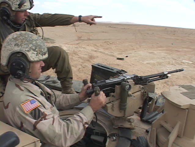 IRAQ - CIRCA 2003: U.S. soldiers fire a  machine gun from an Abrams tank circa 2003 in Iraq.