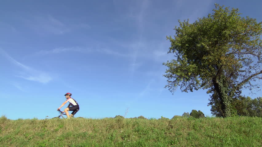 race and sports activity: young adult cyclist riding bicycle in the country. Sequence