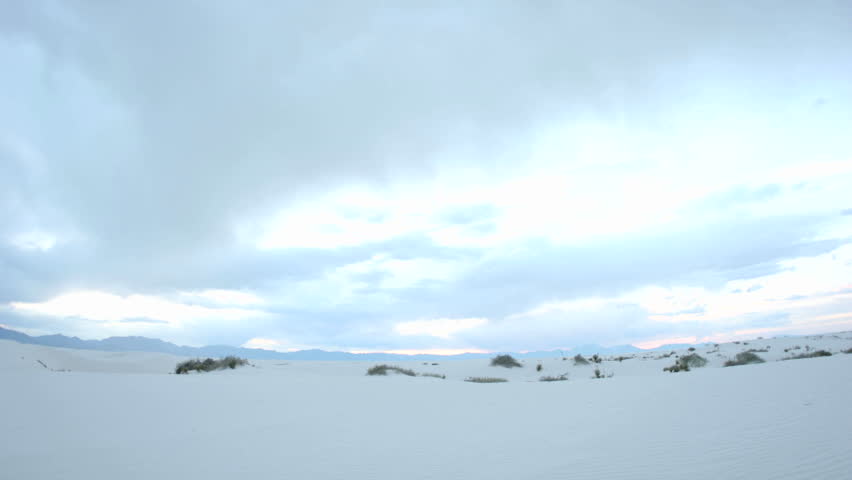 Time lapse shot clouds passing over White Sands National Monument throughout the day, and into the night.