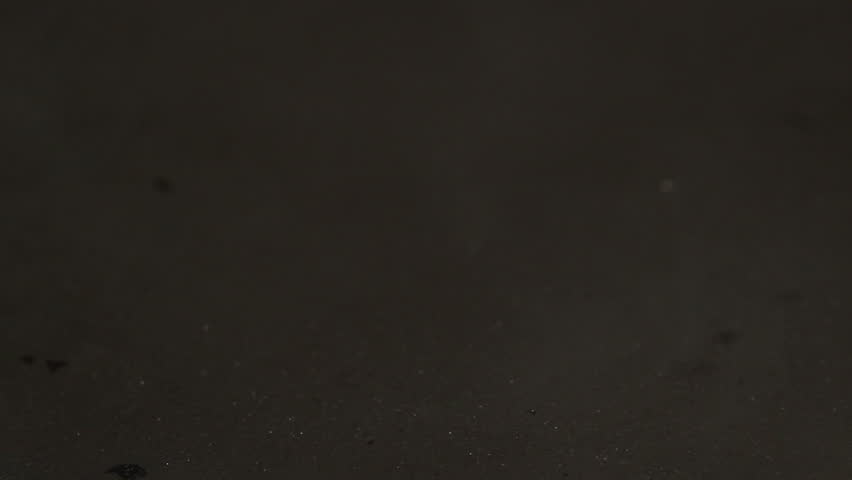 HD macro footage of an egg being dropped in a frying pan, while a second one is cracked and dropped in, frying the eggs. pair of eggs being fried, including sizzing and popping in audio