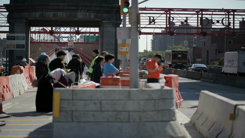 NEW YORK - OCT 6: (Timelapse View) Cars driving onto and people moving on and off the Manhattan side of the Williamsburg bridge on October 6, 2011 in New York. 