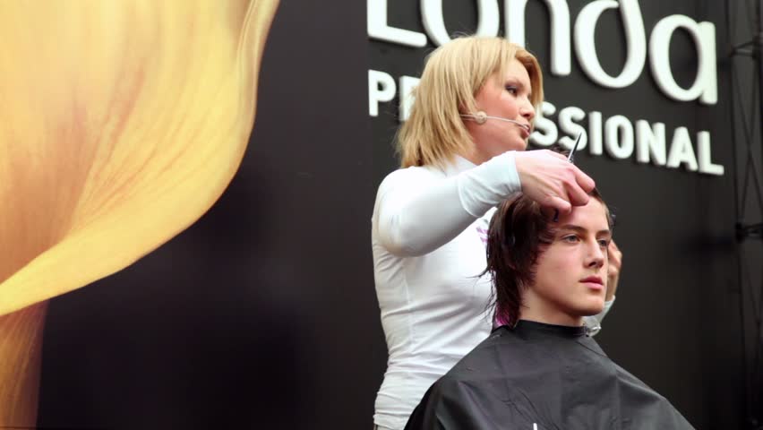 MOSCOW - OCTOBER 2: Hairdresser makes hairstyle at master class from Londa at XVII International Festival World of Beauty 2010 in exhibition complex Gostiny Dvor, on October 2, 2010 in Moscow, Russia.