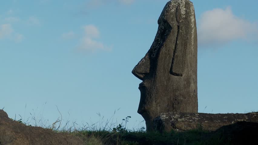 Clouds move behind Easter Island statues.
