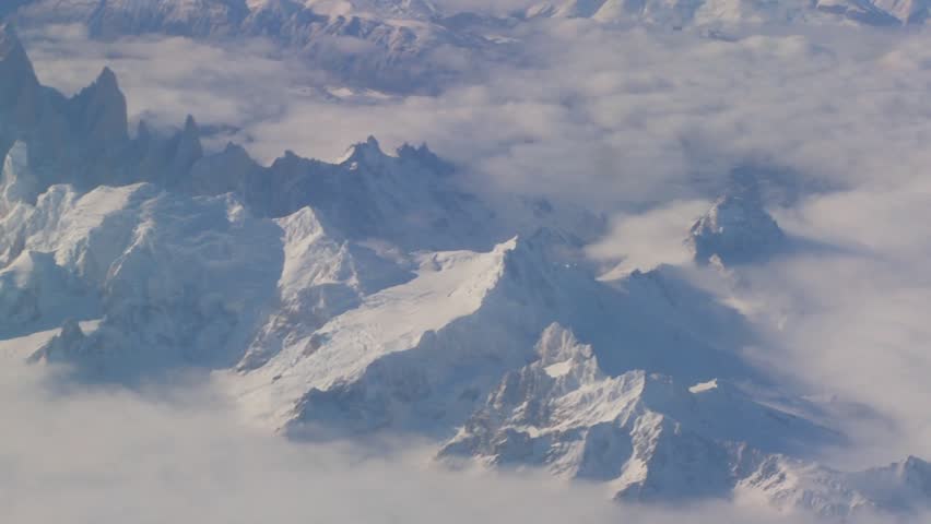 Aerial over the Andes mountain range in patagonia under heavy snow.