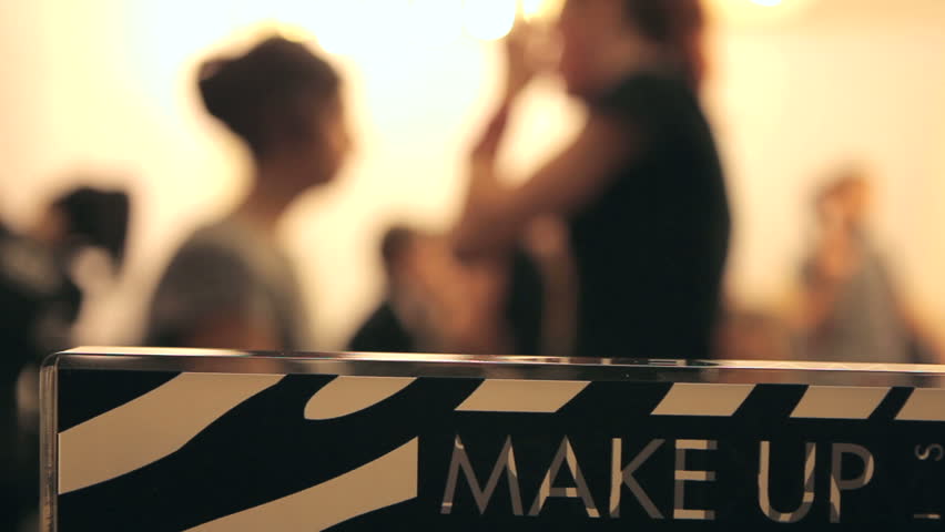 Professional makeup artist putting cosmetics.  Defocus.