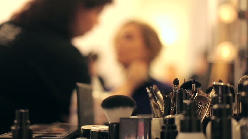 Professional makeup artist putting cosmetics.  Focus on the instrument.