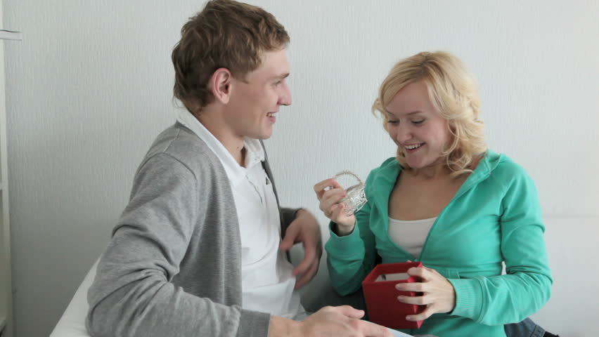 Happy guy giving present to his girlfriend