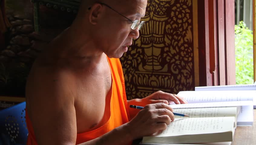 CHIANG MAI, THAILAND - CIRCA AUGUST 2011 - Buddhist monk in Wat Chiang Mun reads Buddhist text, circa August 2011, Chiang Mai, Thailand.  Buddhism in Thailand is represented by the presence of Buddhist monks, who are responsible for preserving and conveyi