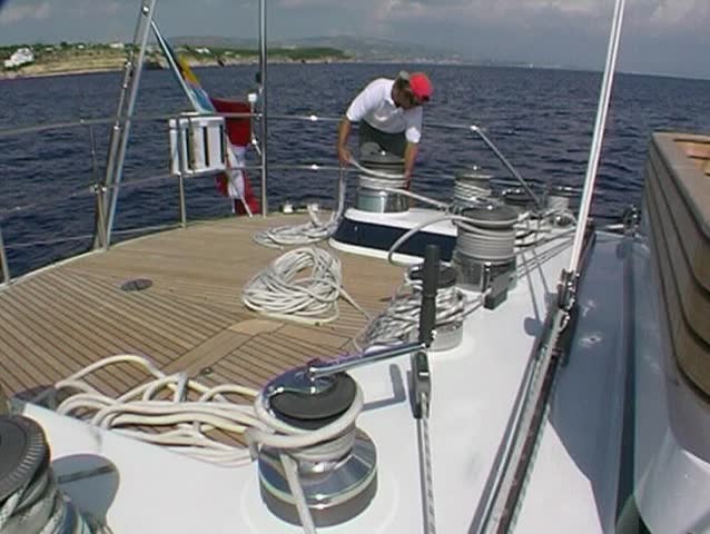 Sailing yacht, crewman at the winch 