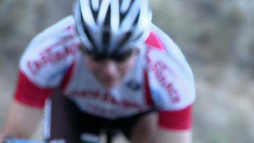 OJAI, CA - CIRCA 2009: A bicycle racer is coasting along a curve in his route circa 2009 in Ojai.