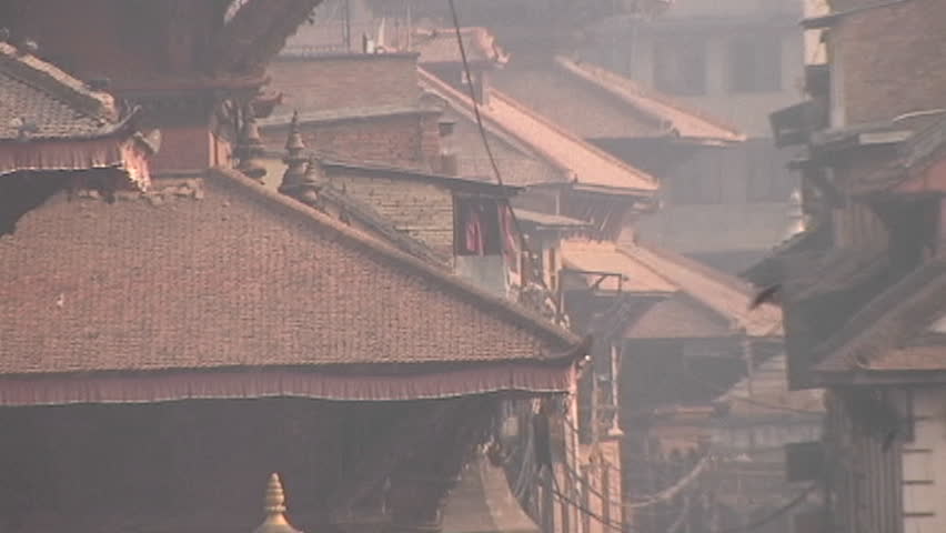 Zoom out to WS of people walking in old city of Patan, Nepal 