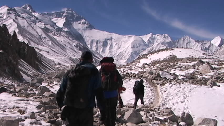 Climbers leaving base camp walking towards the North Face of Mt. Everest